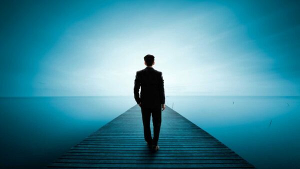 man walking into light