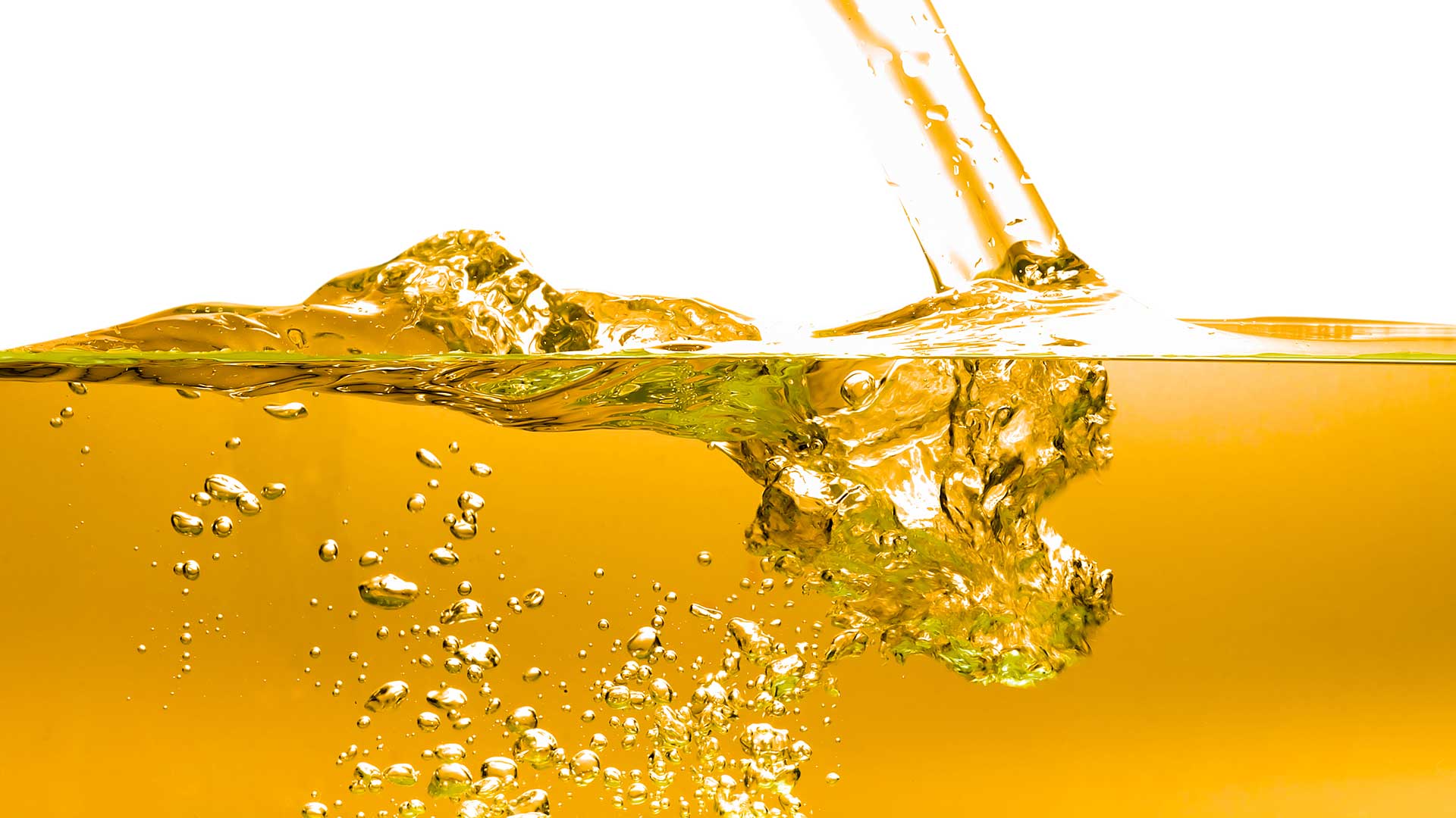 Liquid fuel being poured into a blended fuel mixture representing ethanol, biodiesel, and gasoline fuel storage compatibility in steel tanks.