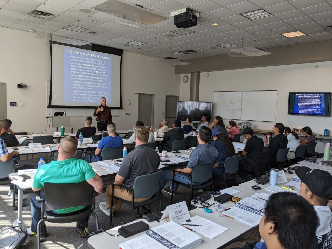 Instructor leading an STI SP001 training class with attendees seated in a classroom-style session.