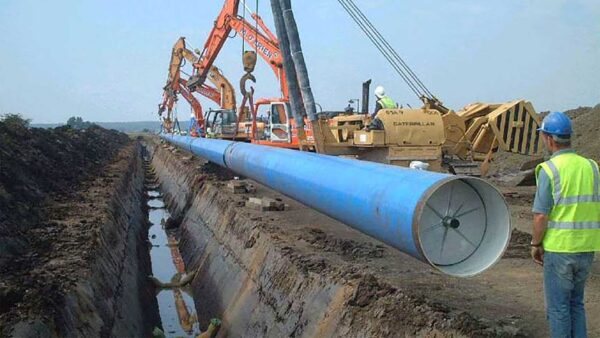 Steel water pipe being installed with cathodic protection.