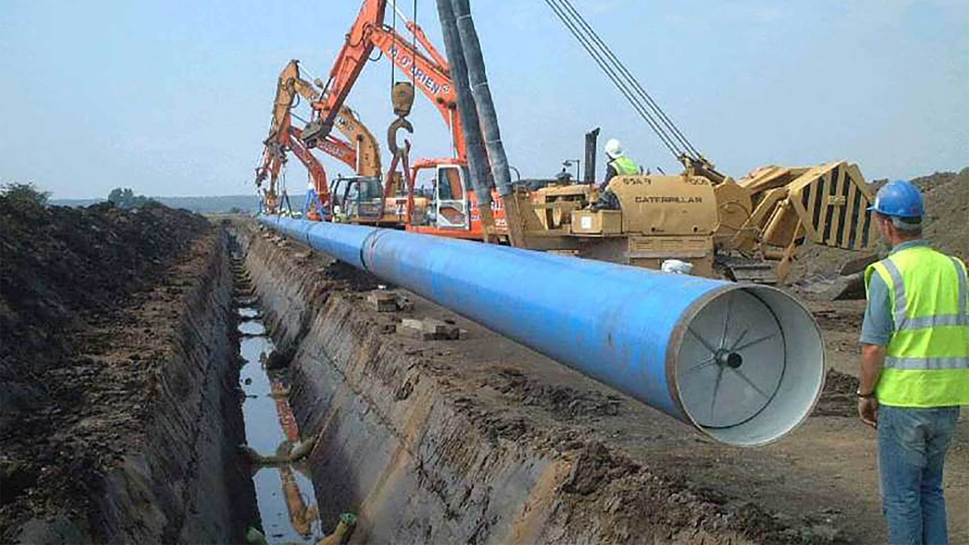 Steel water pipe being installed with cathodic protection.