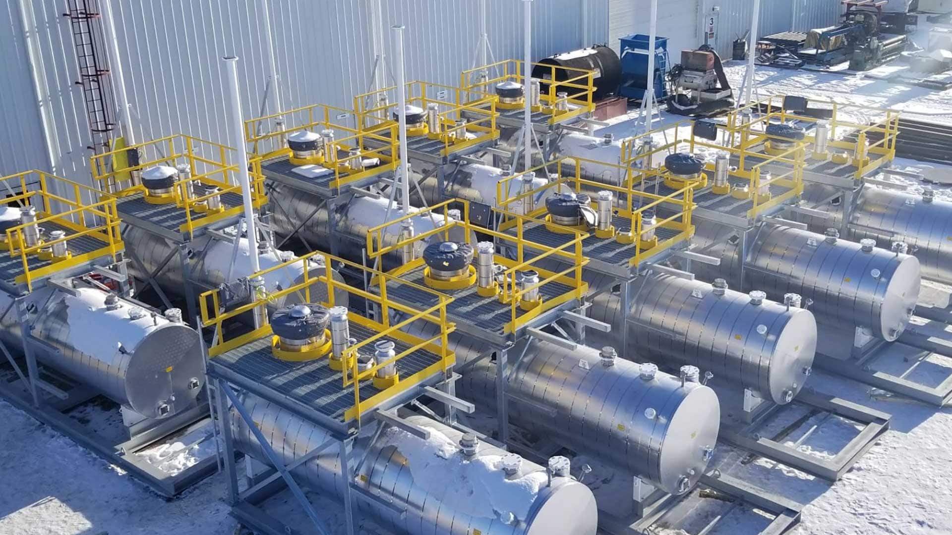 A series of 3,275 US gallon horizontal, integral contained storage tanks labelled ULC S601-14 for the periodic storage of pipeline-grade crude oil at a series of pump stations along a prominent oil pipeline in Canada and the United States.