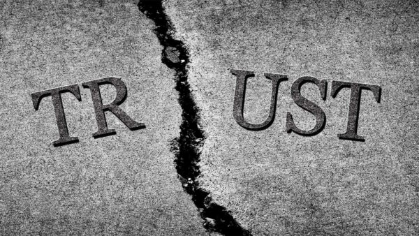 The word TRUST written in cracked concrete.