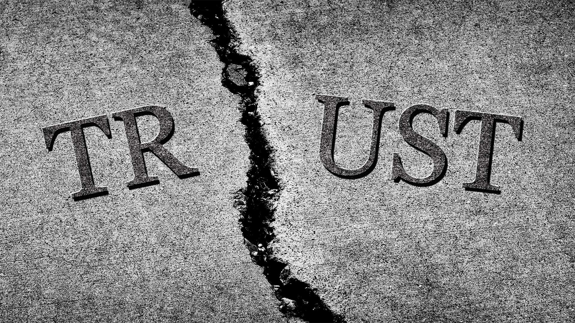 The word TRUST written in cracked concrete.