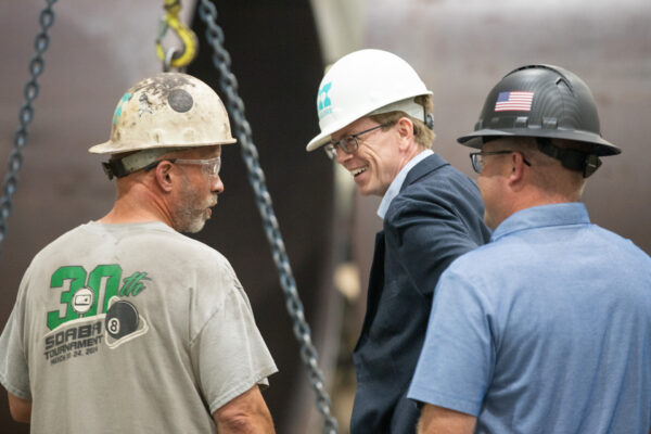 Congressman Dusty Johnson speaking with Maguire team members, Steve Heirigs and Brian Cooper
