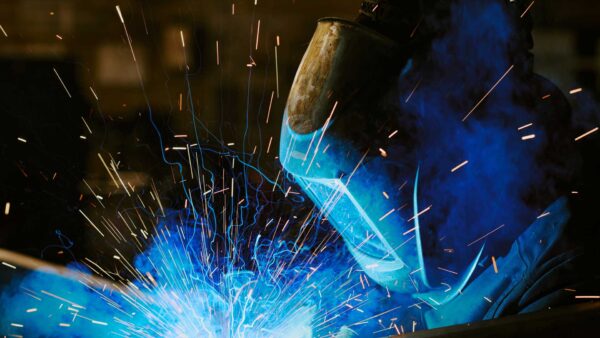 Welder wearing protective helmet.