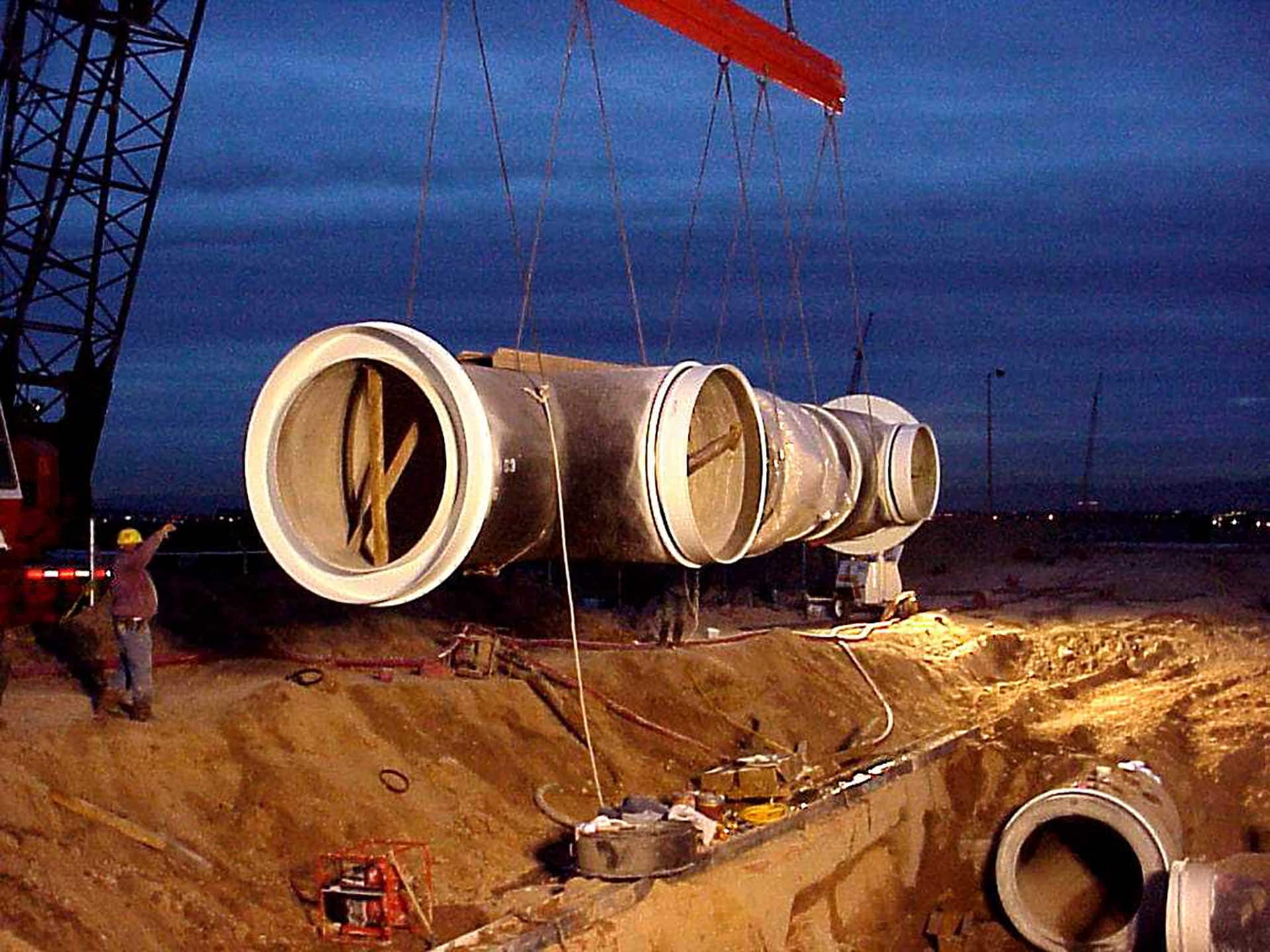 Large diameter header being installed at night