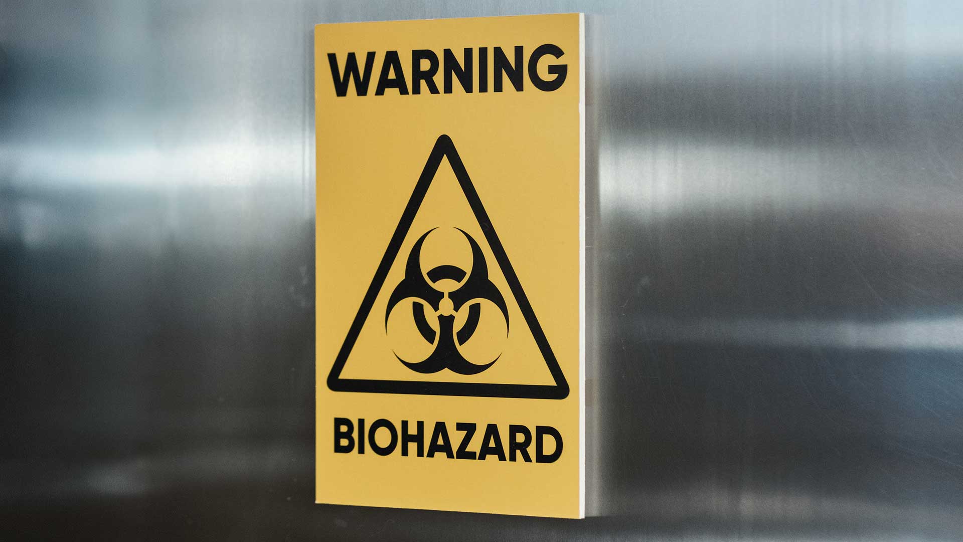 Warning biohazard sign with symbol indicating presence of hazardous biological materials.