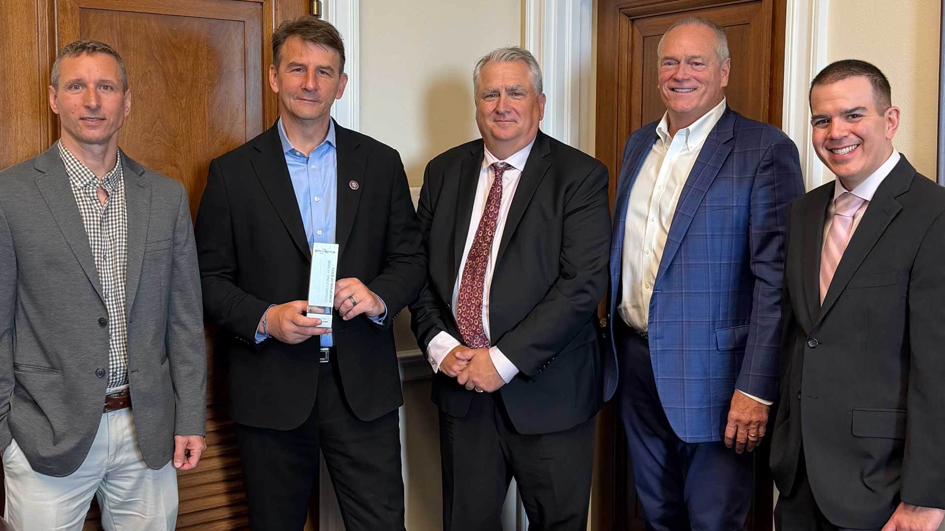 STI/SPFA representatives present Representative Frank Mrvan (second from left) of the 1st District of Indiana with the Champion of Steel Award during the Legislative Fly-In on June 10, 2026.