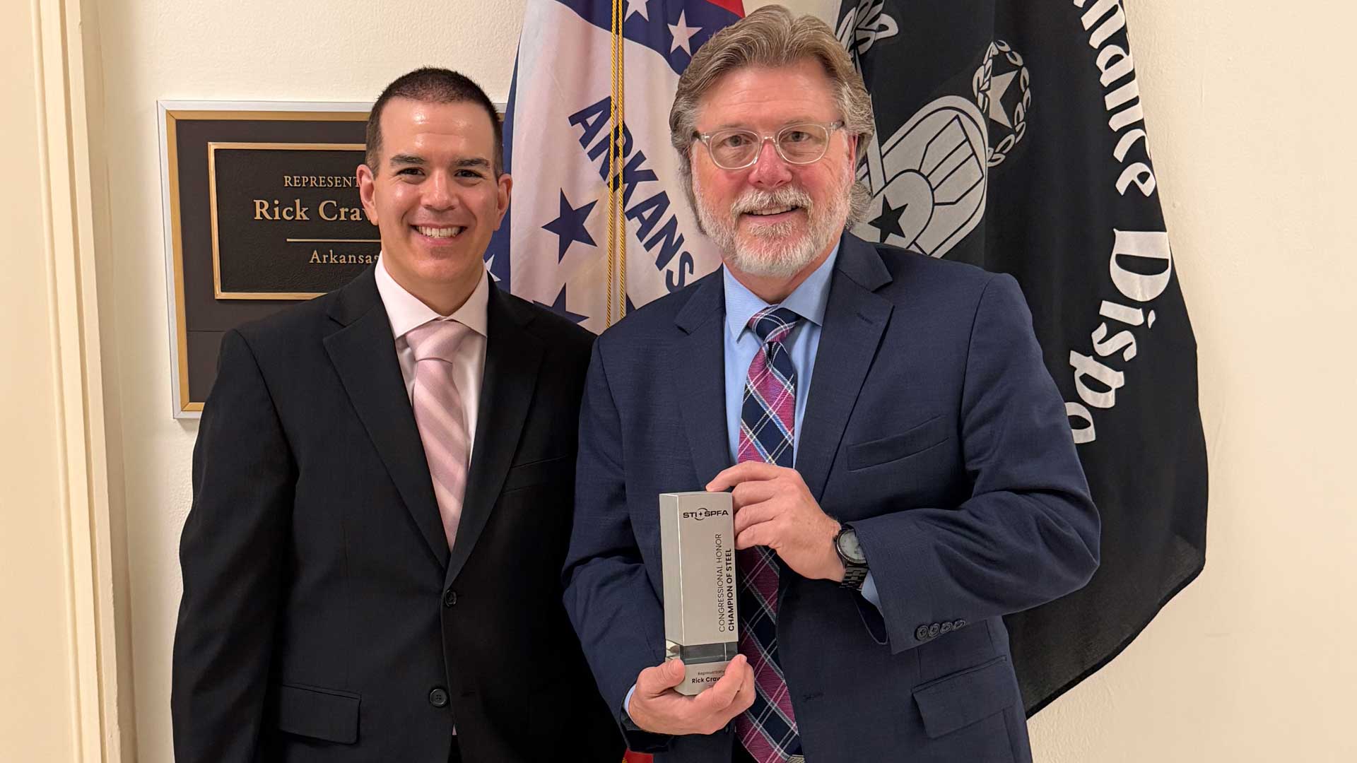 STI/SPFA representatives present Representative Rick Crawford (left) of the 1st District of Arkansas with the Champion of Steel Award during the Legislative Fly-In on June 10, 2026.