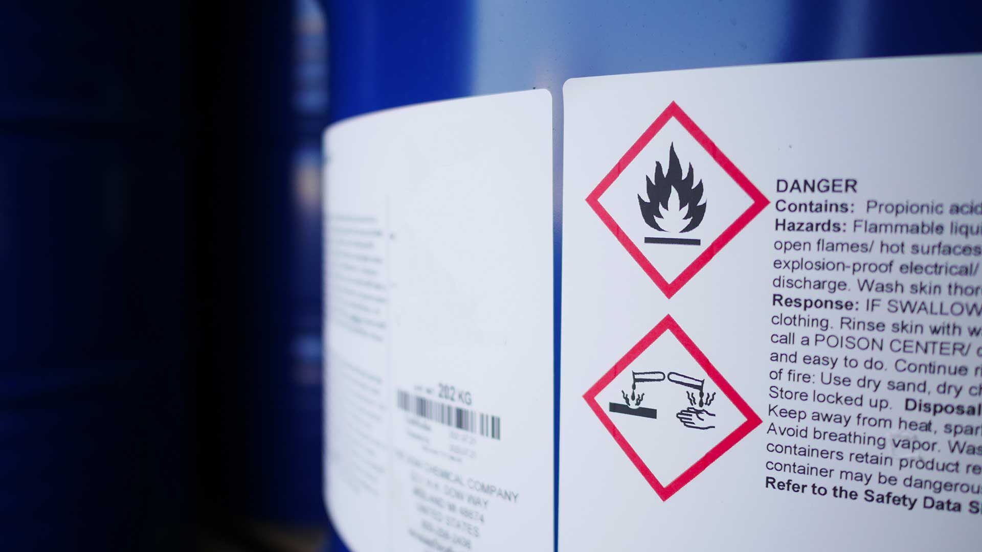 Chemical container label showing flammable and corrosive hazard pictograms for workplace safety.