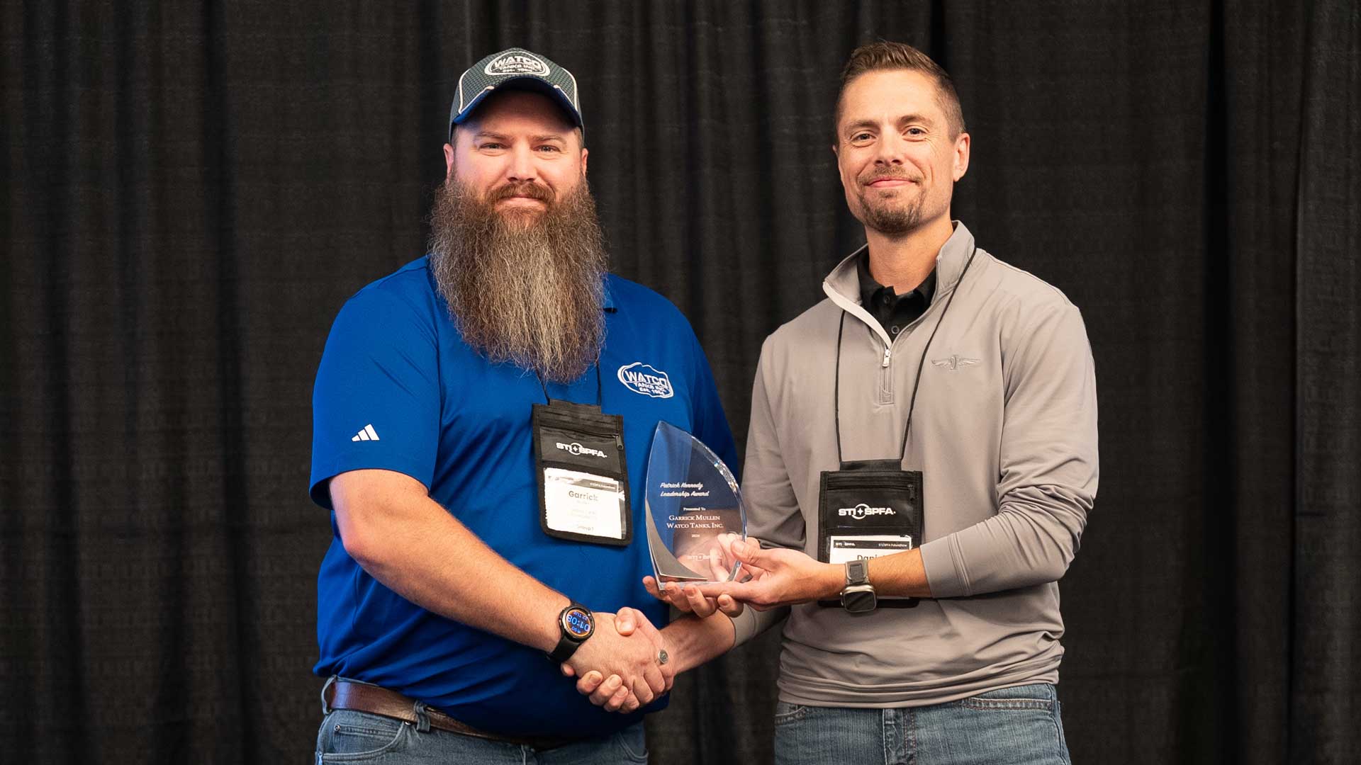 Garrick Mullen of Watco Tanks, Inc. receives the Patrick Kennedy Leadership Award from Dan Yoder of Kennedy Tank.